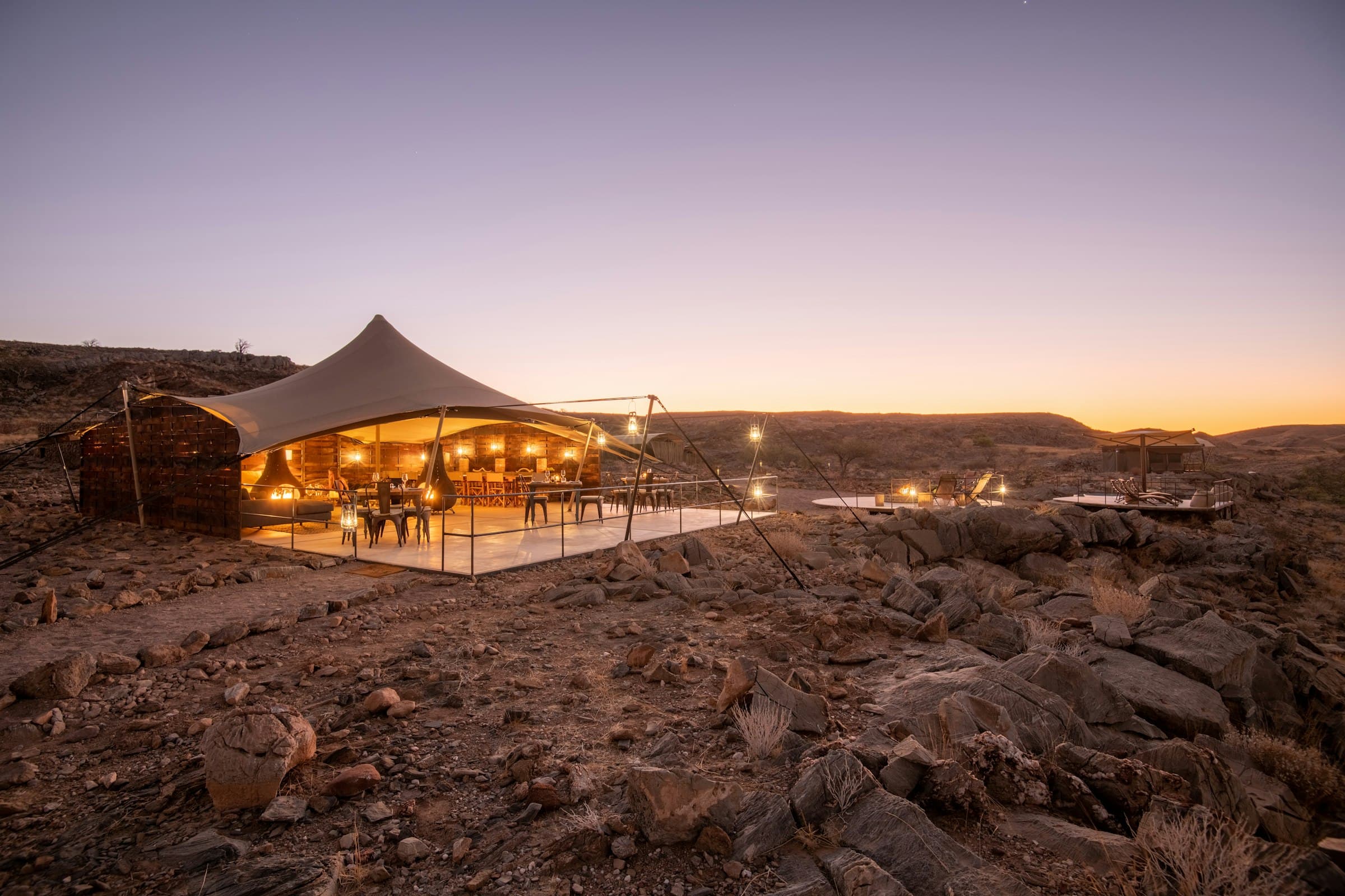A tented suite lit against the dusk